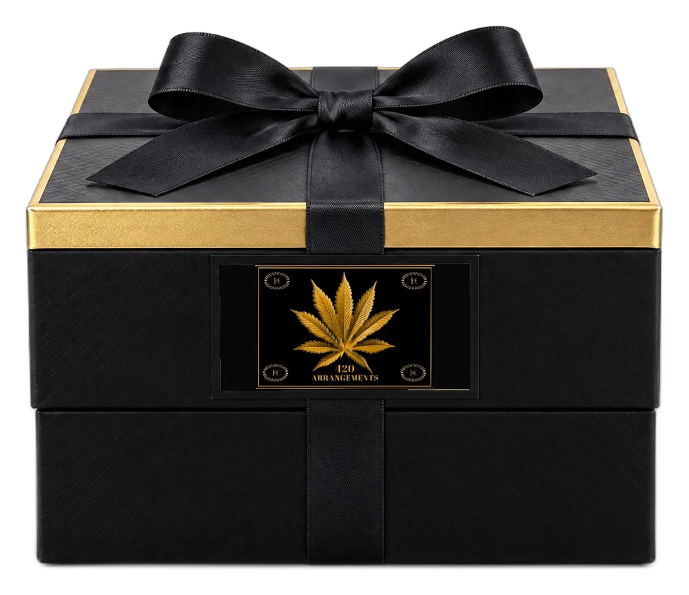 The closed box with its black satin ribbon tied in a bow.